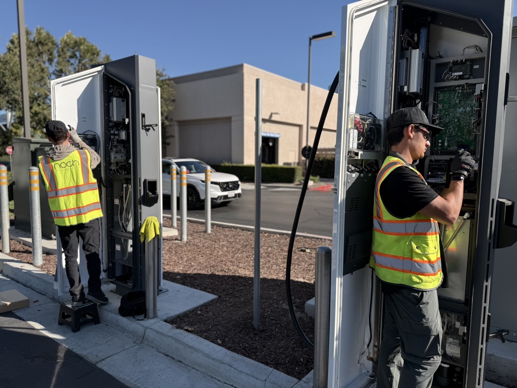 Technicians servicing EV charging stations