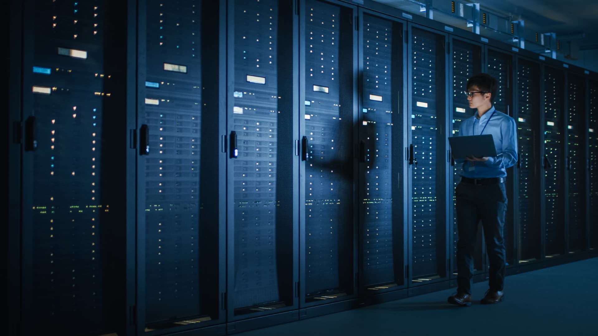 Data center server aisle with blue LED lighting