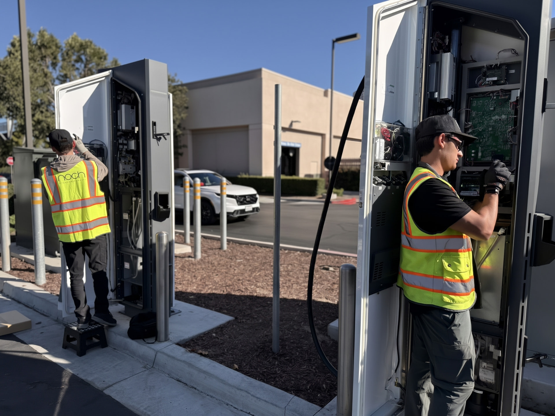Technicians servicing EV charging stations